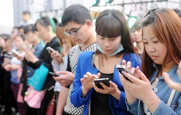 Young Chinese people use smartphones