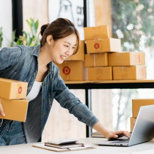 Small Business SME entrepreneur of Young Asian women working with laptop for Online shopping at home,Cheerful and Happy with box for packaging in home,Own Business Start up for Business Online